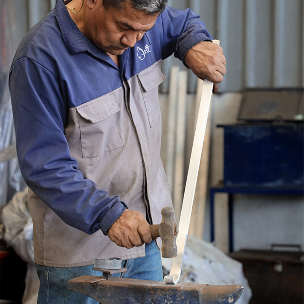 Master Blacksmith working on a bronze forge