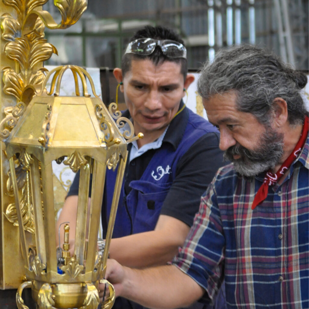 Louis and Fernando working on a bronze lamp
